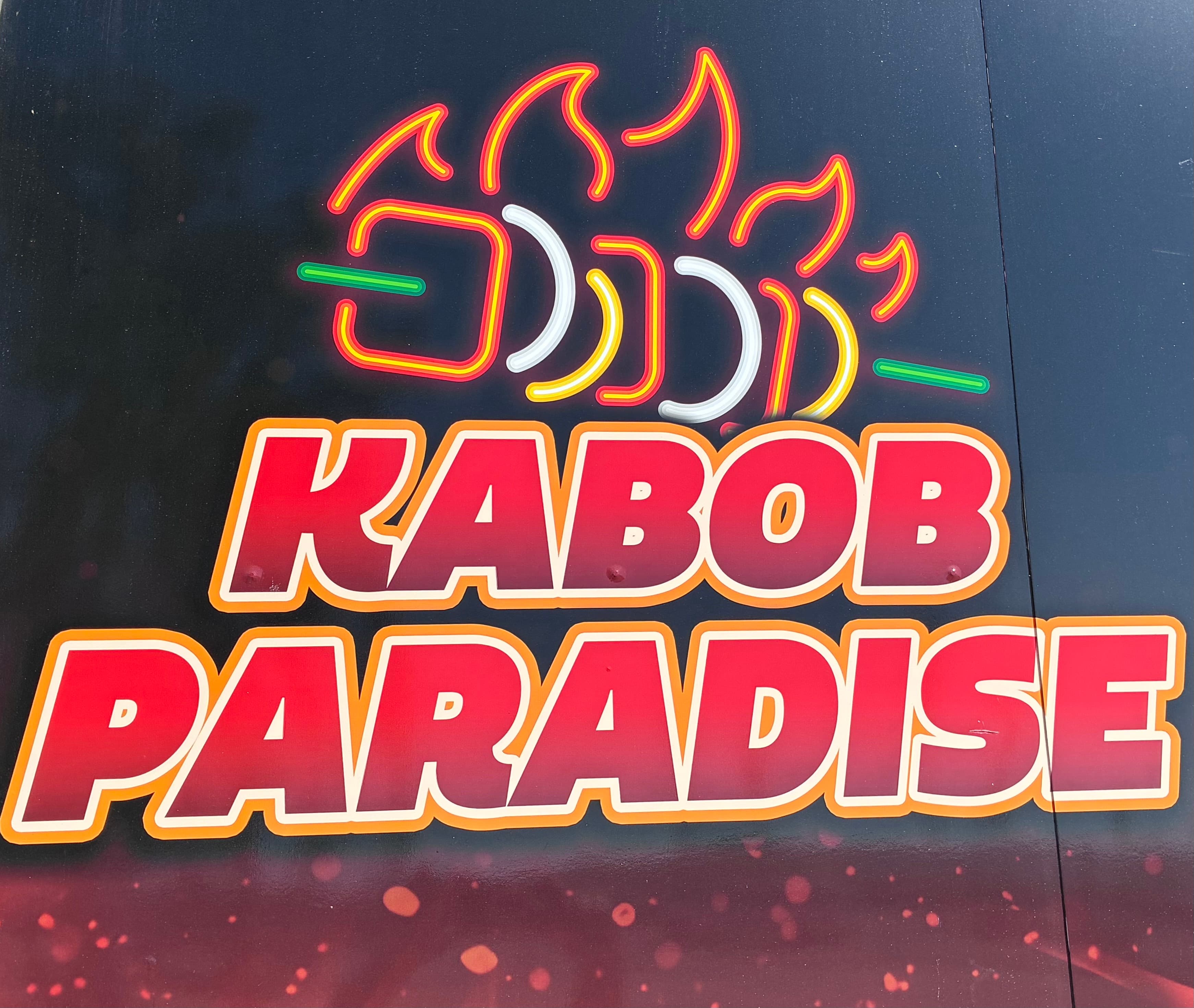 Bold red KABOB PARADISE text below a neon-style graphic of a flaming kabob skewer.